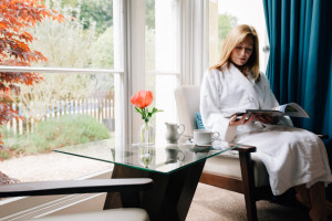 bespoke relaxation spa break lady relaxing with book in guest lounge